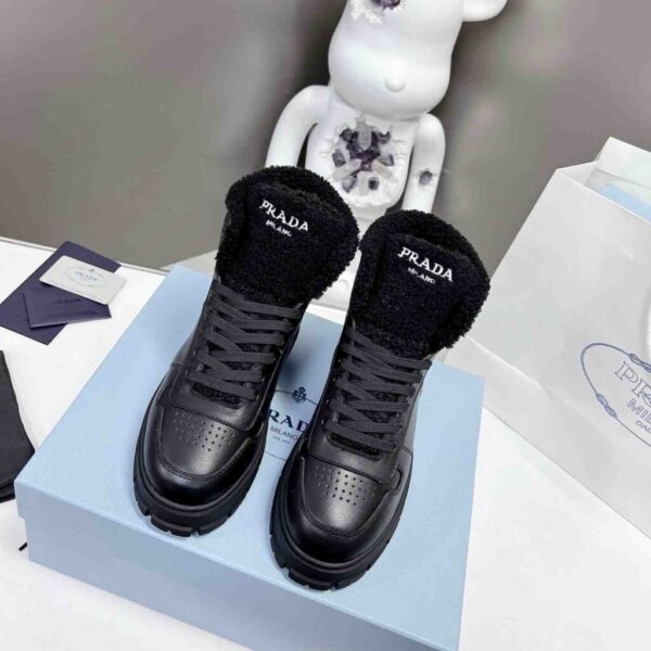 desc_prada-leather-and-shearling-hightop-sneakers_1