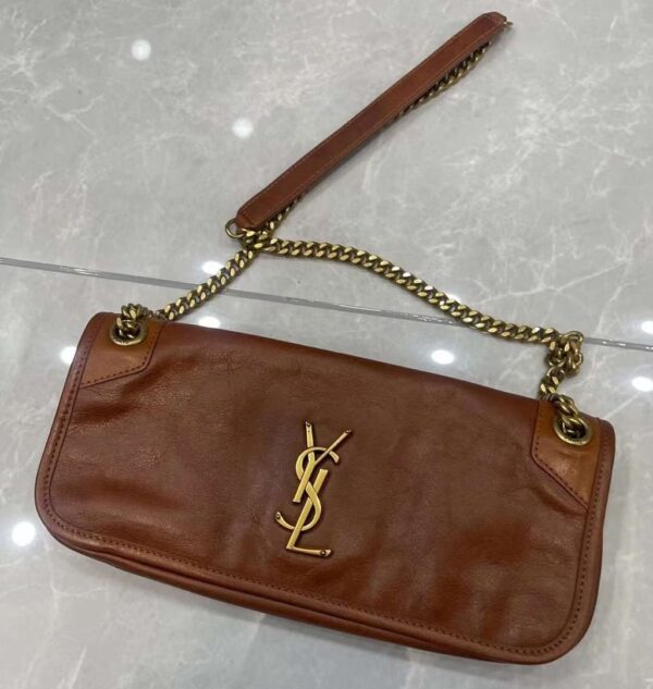 Saint Laurent Bag Medium Niki Chain Satchel in Cognac Calfskin Monogram is a sophisticated yet effortlessly chic accessory, perfect for elevating any outfit. Crafted from luxurious crinkled calfskin leather, the rich Cognac hue adds warmth and depth, while the tonal YSL monogram stitched on the front flap exudes timeless elegance.